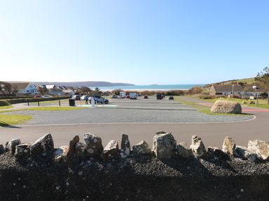 A parking lot near a residential area with a view of the sea at Corner Cottage in Broad Haven
