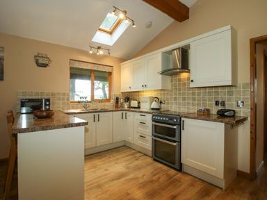 A kitchen with countertops and appliances at Valley View Lodge in Welshpool