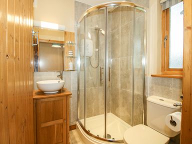 A bathroom with a shower, sink, and toilet at Valley View Lodge in Welshpool