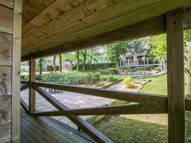 A view of a garden with a shed from a wooden structure at Valley View Lodge in Welshpool