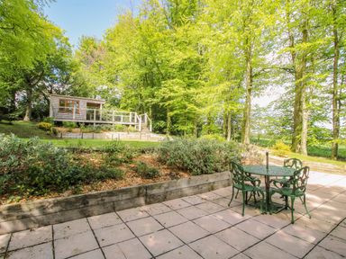 A garden with a table and chairs at Valley View Lodge in Welshpool
