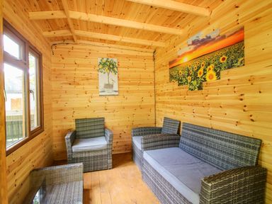 A snug with seating and wall art at Valley View Lodge in Welshpool