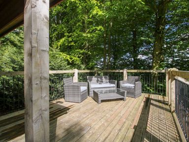 An outdoor area with seating and trees at Valley View Lodge in Welshpool