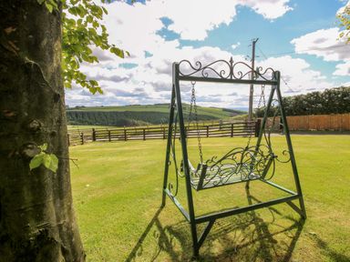 A swing in a garden at Valley View Lodge in Welshpool