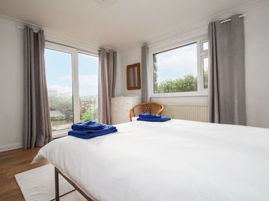 A bedroom with a bed and towels at Tregiffian Vean Sennen Cove