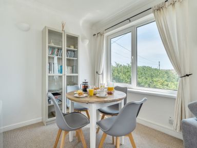A dining room with a table and chairs at The Lookout Sennen