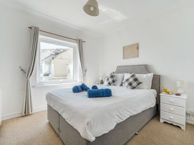 A bedroom with a bed and nightstand at The Lookout in Sennen