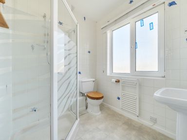 A bathroom with a shower and toilet at The Lookout in Sennen