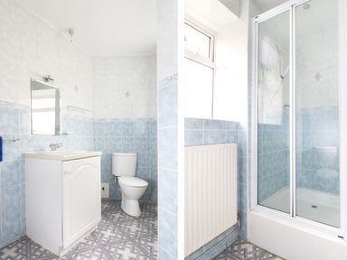 A bathroom with a sink vanity and toilet and a separate shower cubicle with blue tiles at The Coach House in Sennen near St Just