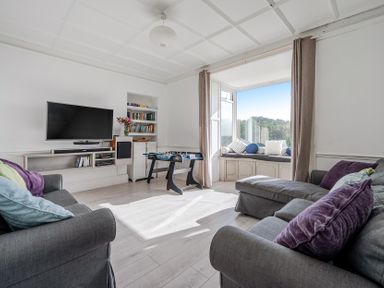 A living room with a television and foosball table at Carn Eve Sennen Cove near St Just