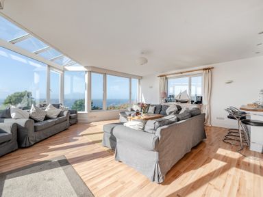 A living room with sofas and a coffee table at Carn Eve in Sennen Cove near St Just