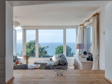 A living room with a view of the ocean at Carn Eve Sennen Cove near St Just