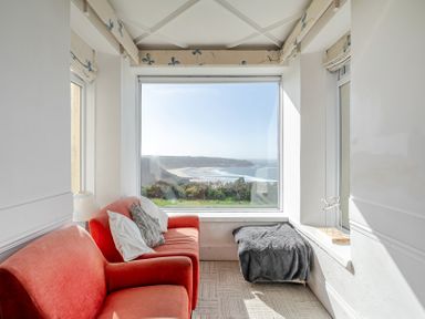 A snug area with a sofa and beach view at Carn Eve Sennen Cove near St Just