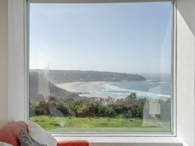 A view of the ocean and beach from a window at Carn Eve Sennen Cove near St Just