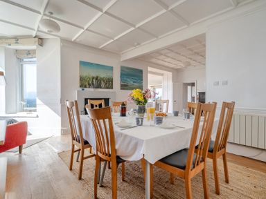 A dining room with a table set for meals at Carn Eve Sennen Cove near St Just