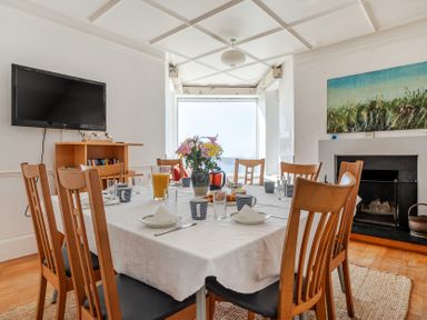 A dining room with a table set for meals at Carn Eve Sennen Cove near St Just