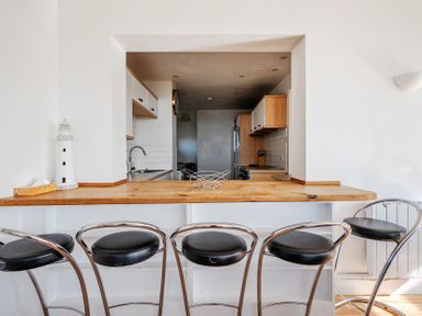 A kitchen with bar counter and stools at Carn Eve Sennen Cove near St Just