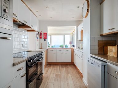 A kitchen with an oven and cupboards at Carn Eve Sennen Cove near St Just