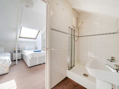 A bathroom with shower and wash basin at Carn Eve Sennen Cove near St Just