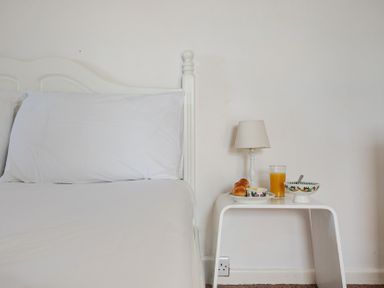 A bedroom with a bed and breakfast items at Carn Eve in Sennen Cove near St Just