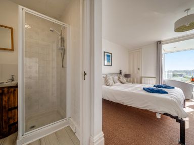 A bedroom with a shower and bed at Carn Eve Sennen Cove near St Just