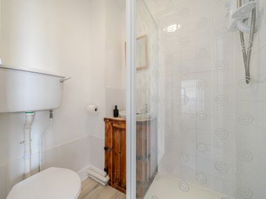 A bathroom with a shower and toilet at Carn Eve Sennen Cove near St Just