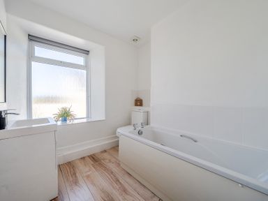 A bathroom with a bathtub and sink at Carn Eve in Sennen Cove near St Just