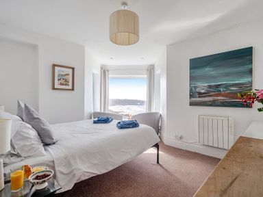 A bedroom with a bed and breakfast tray at Carn Eve in Sennen Cove near St Just