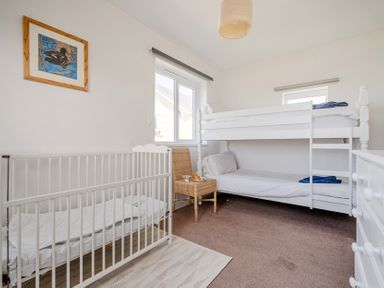 A bedroom with a bunk bed and crib at Carn Eve in Sennen Cove near St Just