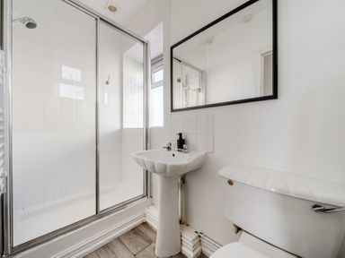 A bathroom with a shower, sink, and toilet at Carn Eve Sennen Cove near St Just