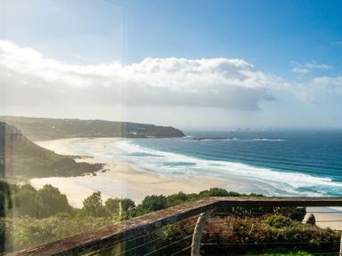 A coastal view with cliffs and sandy beach at Carn Eve Sennen Cove near St Just