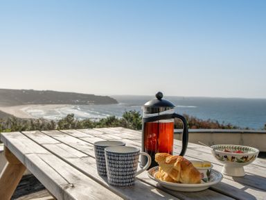 An outdoor dining area with breakfast items at Carn Eve Sennen Cove near St Just