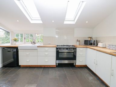 A kitchen with a sink dishwasher oven microwave toaster and cabinets at The Dale Cottage Allendale near Hexham