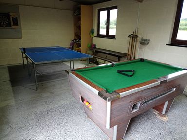 A game room with a pool table and a ping pong table at Dolau Farmhouse in Lampeter