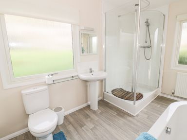 A bathroom with a toilet a sink a shower enclosure and a bathtub at Middle Hivron in Bleddfa