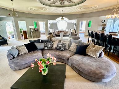 A living room with a sectional sofa and coffee table at Capel Mawr Llanrug near Llanberis