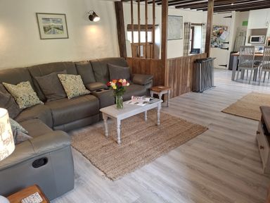 A living room with a sofa and coffee table at Owl's Nest South Molton