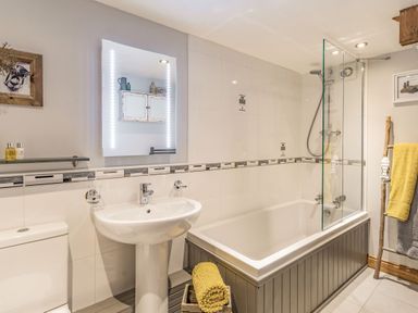 A bathroom with a sink toilet bathtub shower and towels at Berts Cottage Heights near Appleby-in-Westmorland