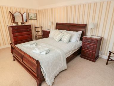 A bedroom with a wooden bed and nightstands in Iona 10 Palace Street East Berwick-upon-Tweed