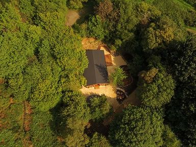 An aerial view of a building surrounded by trees and greenery at Wilderness Lodge in Stiperstones