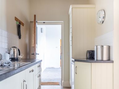 A kitchen with countertop appliances and an open door at Buttermere in Sawrey near Hawkeshead