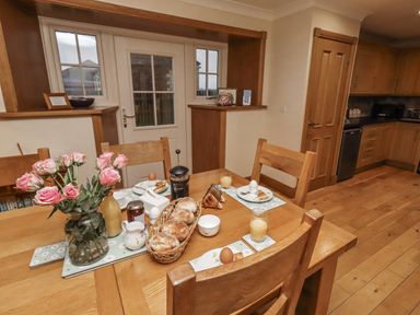 A kitchen with a dining table set for breakfast at Long Cart Cottage in Embleton