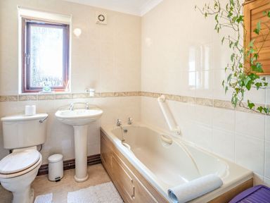 A bathroom with a bathtub a sink and a toilet at Highbury in Spittal near Haverfordwest