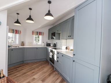 A kitchen with cabinets and appliances at Croft View in Fylingthorpe near Robin Hood's Bay