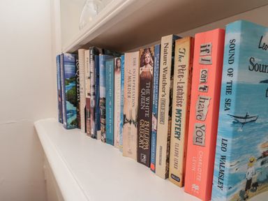 A bookshelf filled with various books at Croft View in Fylingthorpe near Robin Hood's Bay