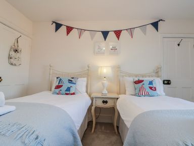 A bedroom with two single beds and a bedside table at Croft View in Fylingthorpe near Robin Hood's Bay