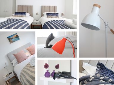 A bedroom with two single beds blue striped blankets and pillows at Saltwater One Lusty Glaze in Newquay