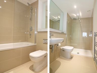 A bathroom with a bathtub shower and toilet on one side and a bathroom with a walk-in shower sink and toilet on the other side at Saltwater One Lusty Glaze in Newquay