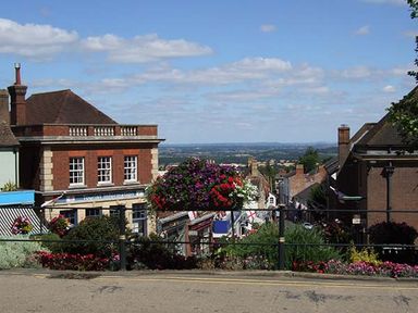 A street view with buildings flowers and a distant landscape at Kitts Cottage in Little Malvern near Malvern