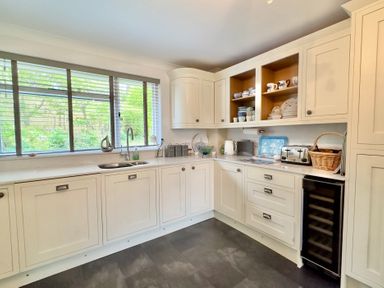 A kitchen with cabinets and appliances at Kilcarreg in Rock near Wadebridge